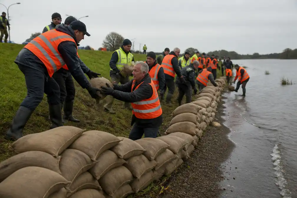 Vrijwilligers oefenen dijkversterking met zandzakken op zes plekken in Nederland