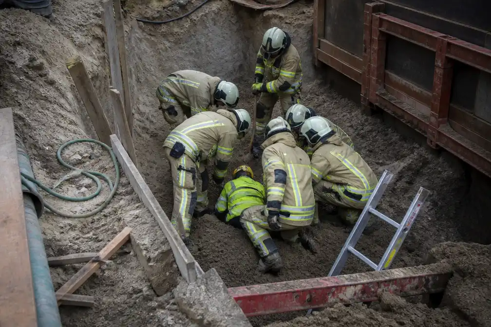Arbeider half bedolven in werfput in Schaarbeek, gered door brandweer